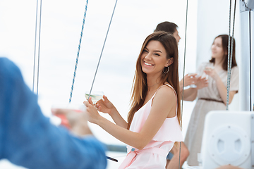 Image showing Happy smiling woman drinking vodka cocktails at boat party outdoor, cheerful and happy