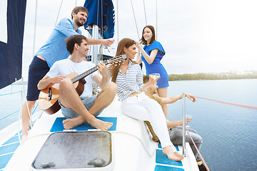 Image showing Group of happy friends drinking vodka cocktails at boat party outdoor, cheerful and happy