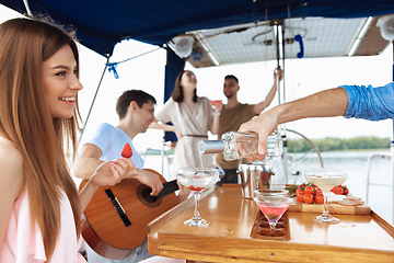 Image showing Group of happy friends drinking vodka cocktails at boat party outdoor, cheerful and happy