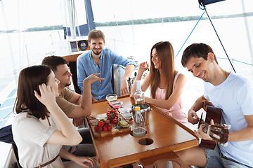 Image showing Group of happy friends drinking vodka cocktails at boat party outdoor, cheerful and happy