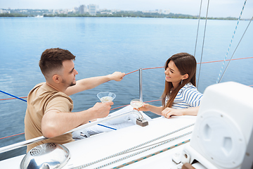 Image showing Happy couple drinking vodka cocktails at boat party outdoor, cheerful and happy