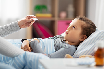 Image showing mother measuring temperature of sick daughter