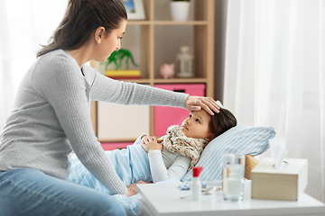 Image showing mother measuring temperature of sick daughter