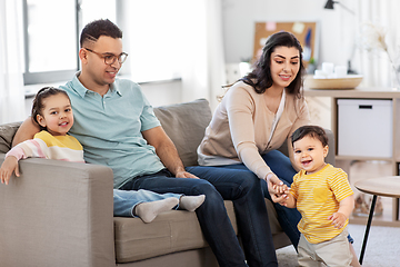 Image showing portrait of happy family sitting on sofa at home