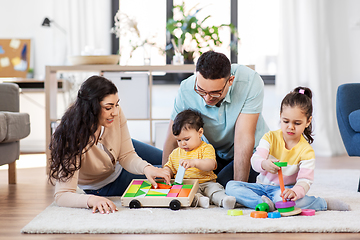 Image showing happy family palying with wooden toys at home