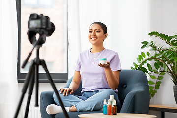 Image showing female beauty blogger with camera and cosmetics