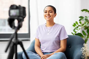 Image showing female blogger with camera video blogging at home