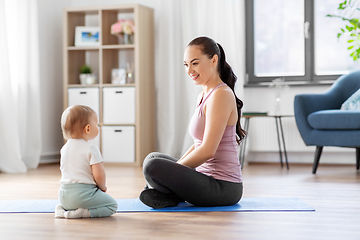 Image showing happy mother with little baby at home