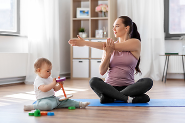 Image showing happy mother with little baby exercising at home