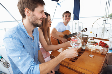 Image showing Group of happy friends drinking vodka cocktails at boat party outdoor, cheerful and happy