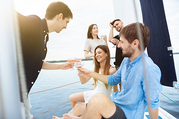 Image showing Group of happy friends drinking vodka cocktails at boat party outdoor, cheerful and happy