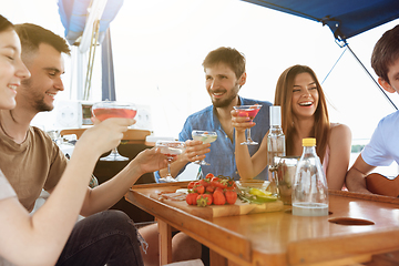 Image showing Group of happy friends drinking vodka cocktails at boat party outdoor, cheerful and happy