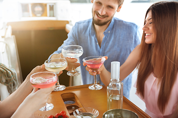 Image showing Group of happy friends drinking vodka cocktails at boat party outdoor, cheerful and happy