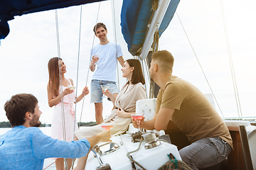 Image showing Group of happy friends drinking vodka cocktails at boat party outdoor, cheerful and happy