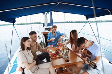 Image showing Group of happy friends drinking vodka cocktails at boat party outdoor, cheerful and happy