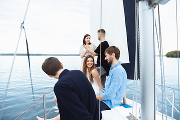 Image showing Group of happy friends drinking vodka cocktails at boat party outdoor, cheerful and happy