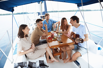 Image showing Group of happy friends drinking vodka cocktails at boat party outdoor, cheerful and happy