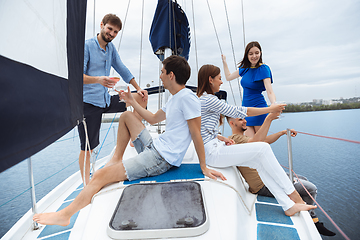 Image showing Group of happy friends drinking vodka cocktails at boat party outdoor, cheerful and happy