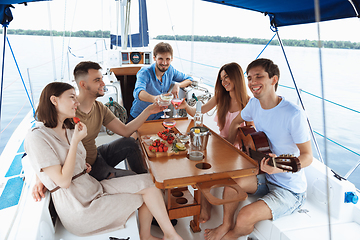 Image showing Group of happy friends drinking vodka cocktails at boat party outdoor, cheerful and happy