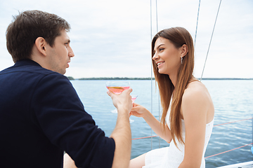 Image showing Happy couple drinking vodka cocktails at boat party outdoor, cheerful and happy