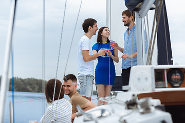 Image showing Group of happy friends drinking vodka cocktails at boat party outdoor, cheerful and happy