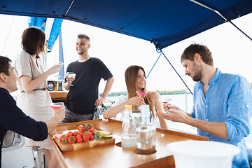 Image showing Group of happy friends drinking vodka cocktails at boat party outdoor, cheerful and happy