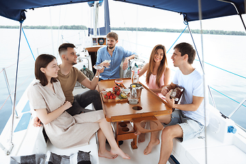 Image showing Group of happy friends drinking vodka cocktails at boat party outdoor, cheerful and happy