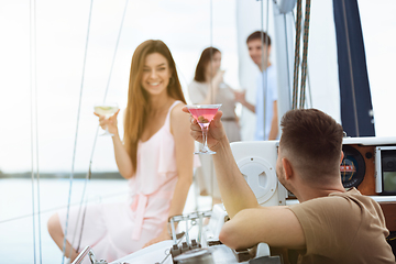 Image showing Happy couple drinking vodka cocktails at boat party outdoor, cheerful and happy