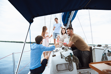 Image showing Group of happy friends drinking vodka cocktails at boat party outdoor, cheerful and happy