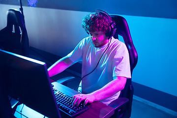 Image showing Cyber sport. Fully concentrated professional cybersport player playing important match