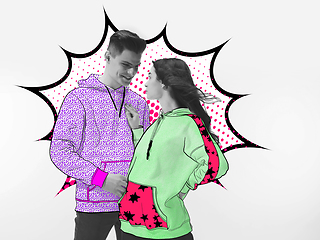 Image showing Casual young stylish couple on white background with colourful art drawings in comics style