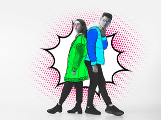 Image showing Casual young stylish couple on white background with colourful art drawings in comics style