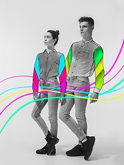 Image showing Casual young stylish couple on white background with colourful art drawings in comics style