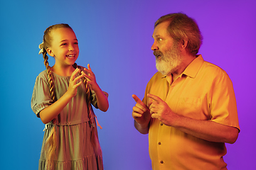 Image showing Senior man, grandfather having fun and spending time together with girl, granddaughter. Joyful elderly lifestyle concept