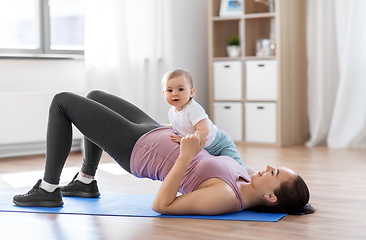 Image showing happy mother with little baby exercising at home