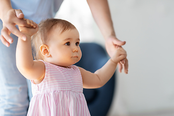 Image showing baby girl learning to walk with mother's help