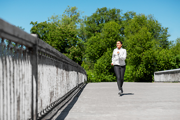 Image showing african american woman running outdoors