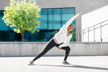 Image showing african american woman doing sports outdoors