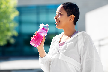 Image showing african american woman drinking water from bottle