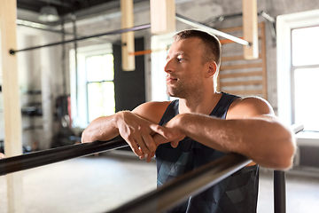 Image showing young man at parallel bars in gym