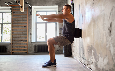 Image showing young man exercising with medicine ball in gym