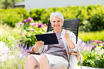 Image showing happy senior woman with tablet pc at summer garden