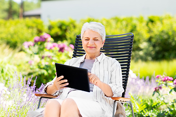 Image showing happy senior woman with tablet pc at summer garden