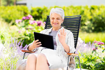 Image showing happy senior woman with tablet pc at summer garden