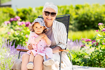 Image showing happy grandmother and baby granddaughter at garden