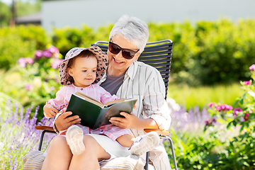 Image showing grandmother and baby granddaughter reading book