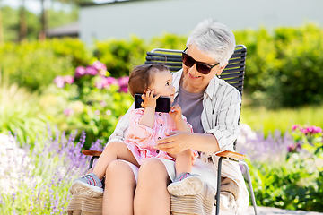 Image showing grandmother and baby granddaughter with smartphone