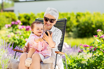 Image showing grandmother and baby granddaughter with phone