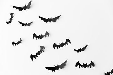 Image showing flock of black paper bats over white background