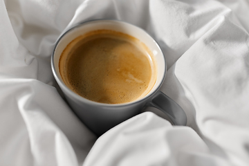 Image showing cup of coffee in bed